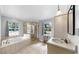 Bright main bathroom with garden tub, glass enclosed shower, and a neutral color palette at 1641 Thompson Rd, Lithia, FL 33547