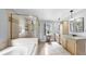 Bright main bathroom with a glass enclosed shower and a garden tub at 1641 Thompson Rd, Lithia, FL 33547