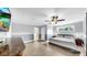 Spacious main bedroom featuring tile floors, light grey walls, ceiling fan, and ensuite bathroom at 1641 Thompson Rd, Lithia, FL 33547