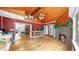 Bright sunroom featuring a brick fireplace, wood ceiling and large windows with views of the backyard and access to kitchen at 1641 Thompson Rd, Lithia, FL 33547