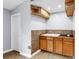 Wet bar area featuring wood cabinets and a tile backsplash at 1641 Thompson Rd, Lithia, FL 33547