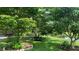 Lush backyard featuring mature fruit trees and a tranquil pond view at 16505 Lake Heather Dr, Tampa, FL 33618