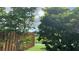 Scenic backyard view featuring mature trees, lush lawn, and tranquil water at 16505 Lake Heather Dr, Tampa, FL 33618