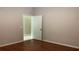 Bedroom with wood-look flooring and a doorway to the next room at 16505 Lake Heather Dr, Tampa, FL 33618