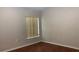 Modest bedroom with wood-look floors, a window, and neutral-toned walls at 16505 Lake Heather Dr, Tampa, FL 33618