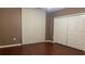 Cozy bedroom features hardwood floors, closet, and vertical blinds at 16505 Lake Heather Dr, Tampa, FL 33618