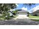 Charming single-Gathering home with a well-manicured lawn and attached two-car garage at 16505 Lake Heather Dr, Tampa, FL 33618
