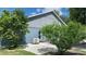Exterior shot of house features a well-maintained backyard and AC unit at 16505 Lake Heather Dr, Tampa, FL 33618