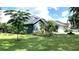 Blue home with lush landscaping, large window, and well-manicured lawn at 16505 Lake Heather Dr, Tampa, FL 33618