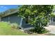 This exterior view highlights the home's well-kept lawn and mature trees at 16505 Lake Heather Dr, Tampa, FL 33618