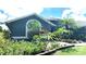 Inviting home exterior with lush landscaping, colorful flowers, and a well-kept lawn at 16505 Lake Heather Dr, Tampa, FL 33618