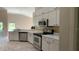 Well-lit kitchen with white cabinets, stainless steel appliances, and a modern faucet at 16505 Lake Heather Dr, Tampa, FL 33618