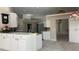 Bright kitchen featuring white cabinets, stainless steel appliances, and tile flooring at 16505 Lake Heather Dr, Tampa, FL 33618