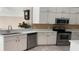Kitchen featuring white cabinets, stainless steel appliances, tile backsplash, and modern sink at 16505 Lake Heather Dr, Tampa, FL 33618