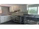 Functional kitchen featuring white cabinetry, tile backsplash, and stainless steel work table at 16505 Lake Heather Dr, Tampa, FL 33618