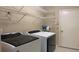 Well-equipped laundry room with washer, dryer, and ample shelving space at 16505 Lake Heather Dr, Tampa, FL 33618