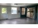 Enclosed living area with tiled flooring, a door and large window to the exterior at 16505 Lake Heather Dr, Tampa, FL 33618