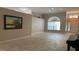 Spacious living room featuring neutral walls, tile floors, and a well-lit atmosphere at 16505 Lake Heather Dr, Tampa, FL 33618
