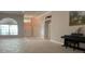 Bright living room with tile flooring, a large window, and an elegant piano at 16505 Lake Heather Dr, Tampa, FL 33618