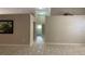 Living room features neutral walls, tile floors, and an open doorway to the bathroom at 16505 Lake Heather Dr, Tampa, FL 33618