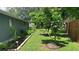 Side yard features a flourishing garden and well-maintained lawn at 16505 Lake Heather Dr, Tampa, FL 33618