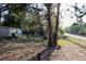 This property has a spacious backyard with mature trees and a chain-link fence at 16536 Caldwell Ln, Spring Hill, FL 34610