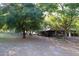 Backyard with mature trees and partial view of home, offering a private outdoor sanctuary at 16536 Caldwell Ln, Spring Hill, FL 34610