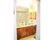 Bathroom featuring double sink vanity and large mirror with tile backsplash at 16536 Caldwell Ln, Spring Hill, FL 34610