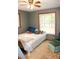 Comfortable bedroom with neutral walls, carpet flooring, and a relaxing armchair at 16536 Caldwell Ln, Spring Hill, FL 34610
