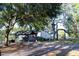 Quaint single-story home with covered parking surrounded by mature trees providing ample shade at 16536 Caldwell Ln, Spring Hill, FL 34610
