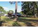 View of the exterior of a home with covered patios, sheds, and garages at 16536 Caldwell Ln, Spring Hill, FL 34610