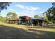 Exterior structure view with open garages and an auto shop at 16536 Caldwell Ln, Spring Hill, FL 34610
