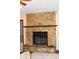 Stunning stone fireplace with wooden mantle creates a cozy and inviting focal point at 16536 Caldwell Ln, Spring Hill, FL 34610
