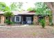 Charming stone and wood home featuring a well maintained front yard and inviting entryway at 16536 Caldwell Ln, Spring Hill, FL 34610
