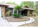 Charming exterior with stone accents, a curved walkway, and manicured landscaping at 16536 Caldwell Ln, Spring Hill, FL 34610