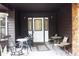 Inviting front porch featuring ample seating space and a stylish entryway with decorative glass door at 16536 Caldwell Ln, Spring Hill, FL 34610