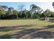 View of the yard with trees, and open space, ideal for recreation and outdoor activities at 16536 Caldwell Ln, Spring Hill, FL 34610