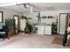 Large garage with laundry facilities and storage shelves, perfect for projects and organization at 16536 Caldwell Ln, Spring Hill, FL 34610