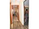 Hallway view with hardwood floors leading to various rooms at 16536 Caldwell Ln, Spring Hill, FL 34610