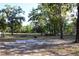 Open lot with mature trees, wooden fencing and native plants at 16536 Caldwell Ln, Spring Hill, FL 34610