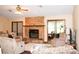 Inviting living room features a stone fireplace and cozy seating, perfect for relaxing or entertaining guests at 16536 Caldwell Ln, Spring Hill, FL 34610