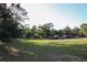 Spacious acreage with lush greenery, mature trees, and outbuildings offering versatile use and potential at 16536 Caldwell Ln, Spring Hill, FL 34610