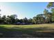 Large acreage featuring a grassy field, mature trees, and multiple outbuildings providing ample storage space at 16536 Caldwell Ln, Spring Hill, FL 34610
