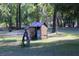Outdoor storage shed with gas pump and dense trees and landscape at 16536 Caldwell Ln, Spring Hill, FL 34610
