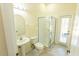 Bathroom showcasing a white vanity, toilet, and glass shower with door to exterior at 16637 Ashton Green Dr, Lutz, FL 33558