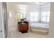 Luxurious primary bathroom featuring a soaking tub, dual vanities, and a walk-in shower at 16637 Ashton Green Dr, Lutz, FL 33558