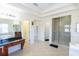 Open layout of a luxurious primary bath with dual vanity sinks, glass shower, and soaking tub at 16637 Ashton Green Dr, Lutz, FL 33558