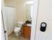 Bathroom featuring a shower with curtain, toilet, and granite vanity with mirror at 16637 Ashton Green Dr, Lutz, FL 33558
