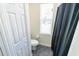 Powder room with a toilet, blinds on the window for privacy, and a small closet at 16637 Ashton Green Dr, Lutz, FL 33558