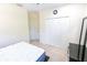 Bright bedroom featuring a double door closet, complemented by dark wood furniture and carpet flooring at 16637 Ashton Green Dr, Lutz, FL 33558